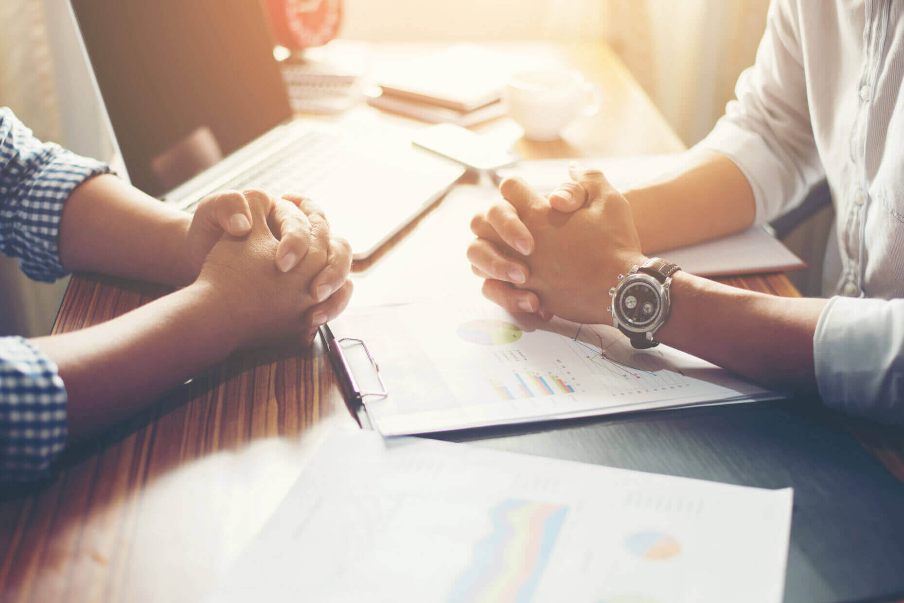 Close Up Of Team Business People Discussing A Financial Plan At